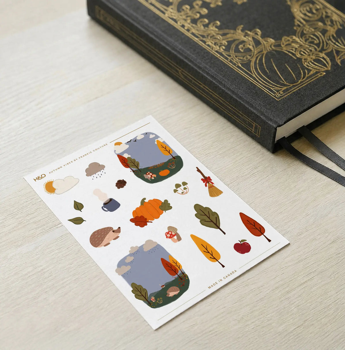 Autumn Vibes sticker sheet by Frankie Couture shown with a notebook