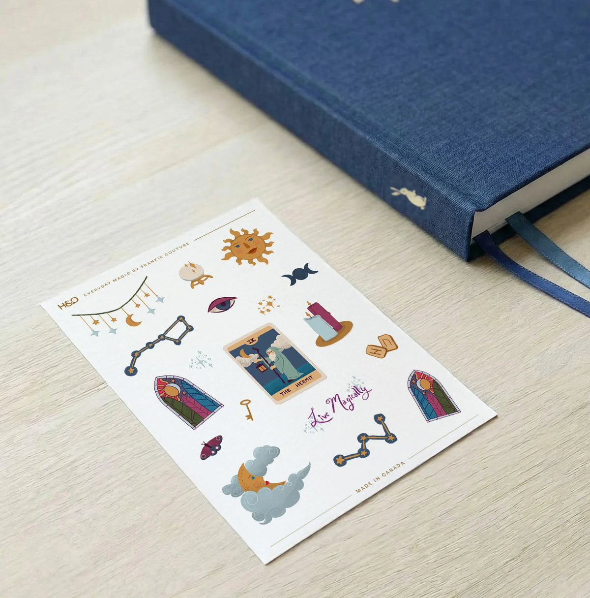 Everyday Magic sticker sheet by Frankie Couture shown with a notebook