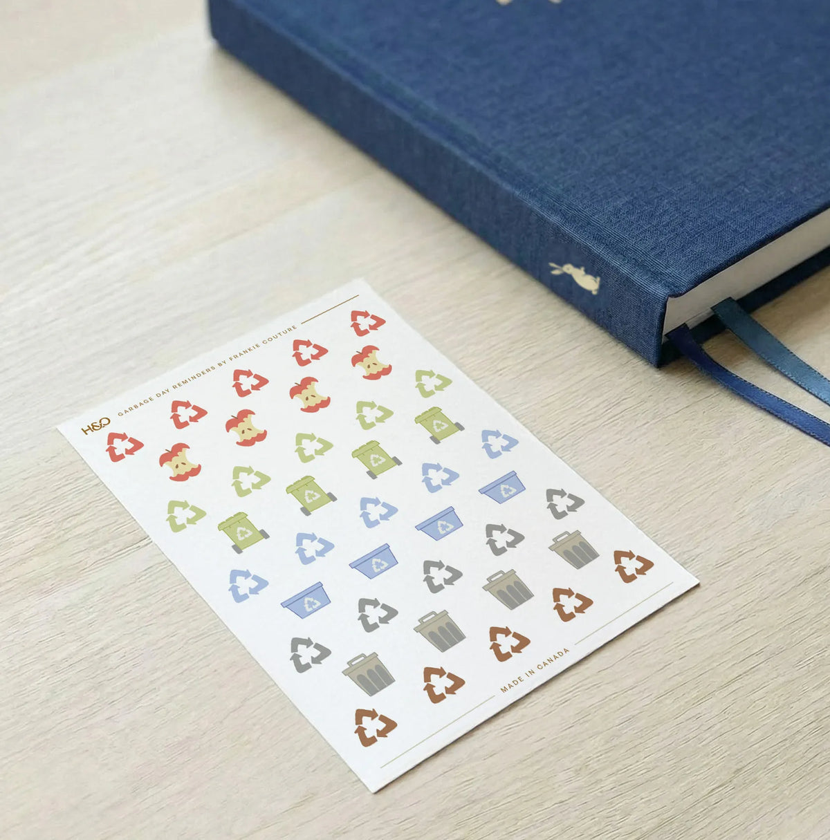 Garbage Day Reminders sticker sheet by Frankie Couture shown with a notebook