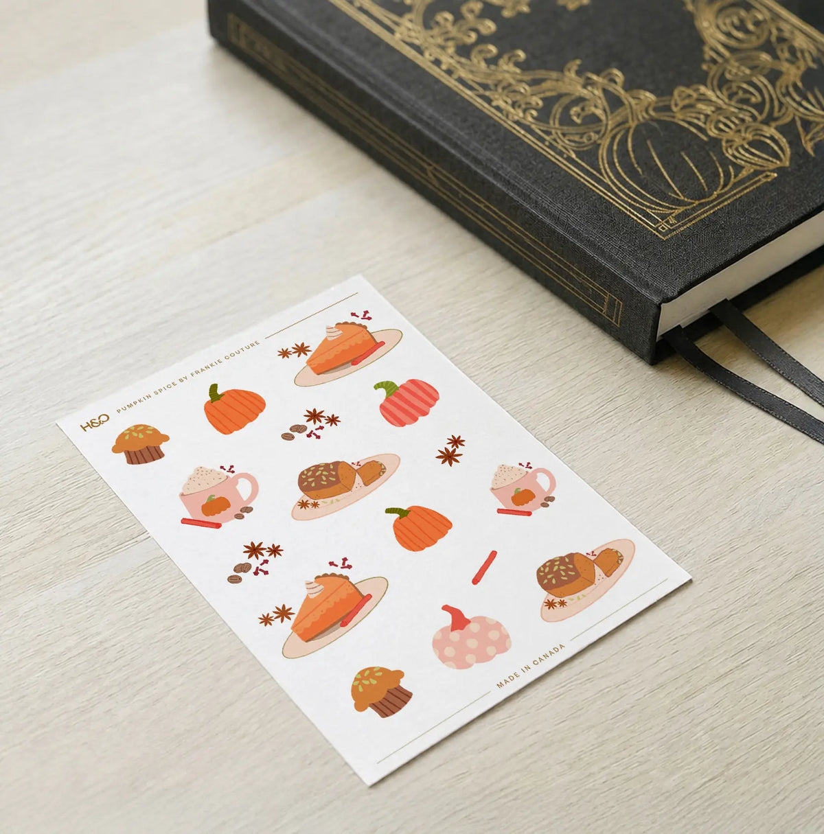 Pumpkin Spice sticker sheet by Frankie Couture shown with a notebook