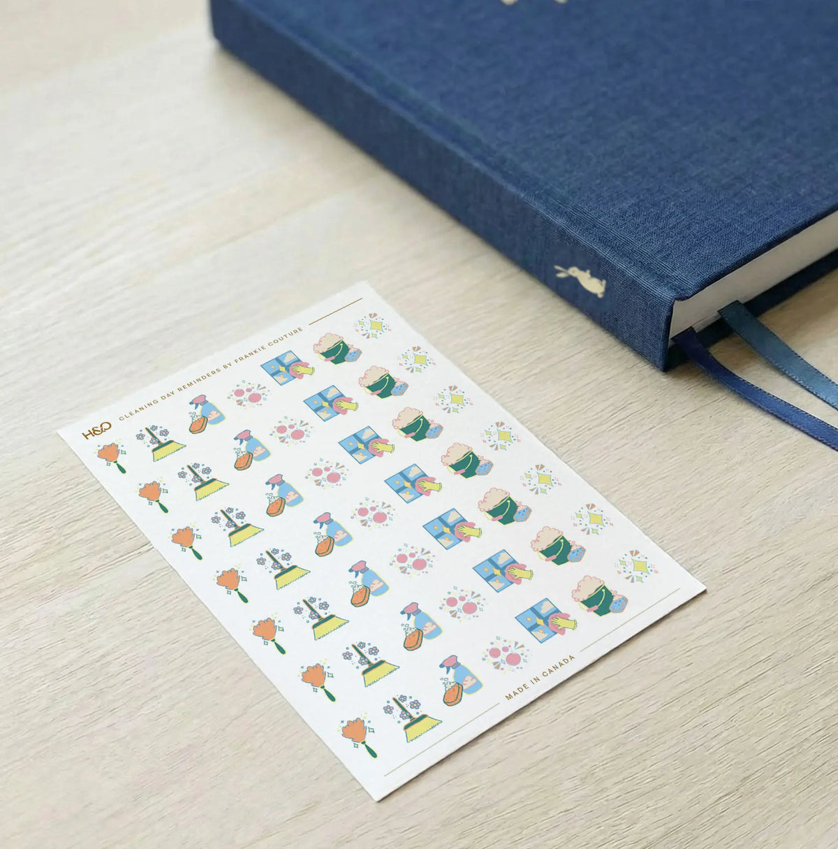 Cleaning Day Reminders sticker sheet by Frankie Couture shown with a notebook