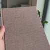 2027 Sunday Start Weekly Planner (Hardcover, Vertical, Heritage 120gsm, A5+) in Fawn, held in hand #color_fawn