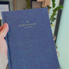 2027 Signature Daily Planner (Hardcover, A5+, Archivist 70gsm) in Wild Indigo, held in hand #color_wild indigo