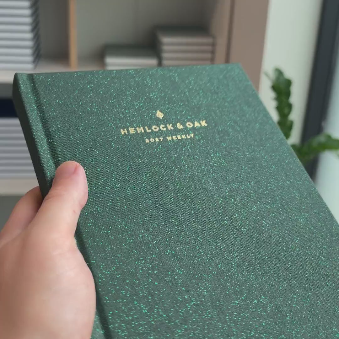 2027 Weekly Planner (Hardcover, Vertical, Heritage 120gsm, A5+) in Mystic Forest, held in hand #color_mystic forest