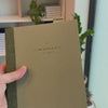 2027 Signature Daily Planner (Paper Flex, A5+, Archivist 70gsm) in Moss, held in hand #color_moss