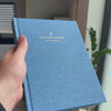 2027 Weekly Planner (Hardcover, Vertical, Heritage 120gsm, A5+) in Spring, held in hand #color_spring