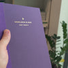 2027 Sunday Start Weekly Planner (Paper Flex, Heritage 120gsm, A5+) in Plum, held in hand #color_plum