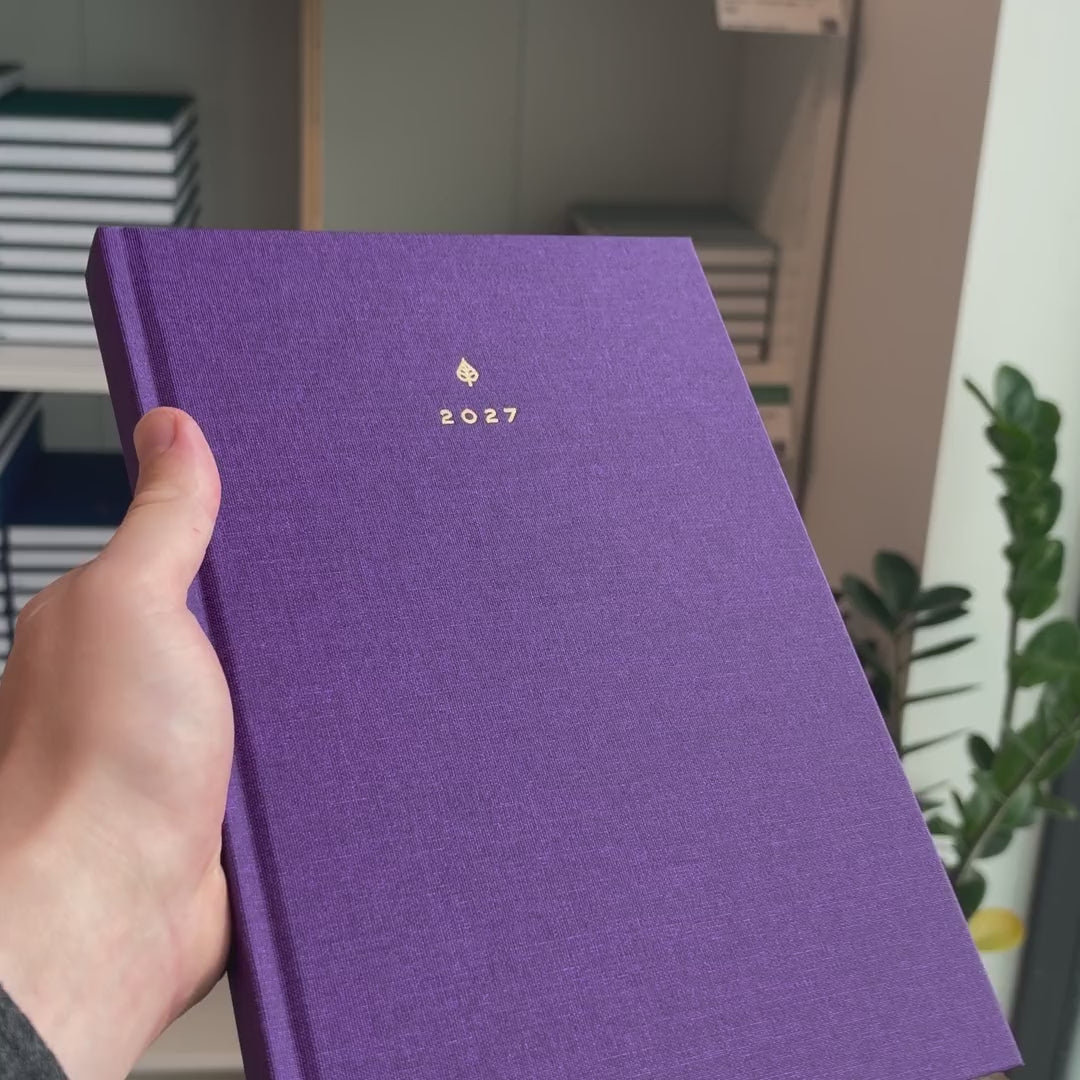 2027 B5 Minimalist Vertical Planner (Hardcover, Heritage 120gsm) in Aura, held in hand #color_aura