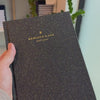 2027 Signature Daily Planner (Hardcover, A5+, Archivist 70gsm) in Witching Hour, held in hand #color_witching hour
