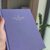 2027 Weekly Planner (Hardcover, Vertical, Heritage 120gsm, A5+) in Fae, held in hand #color_fae
