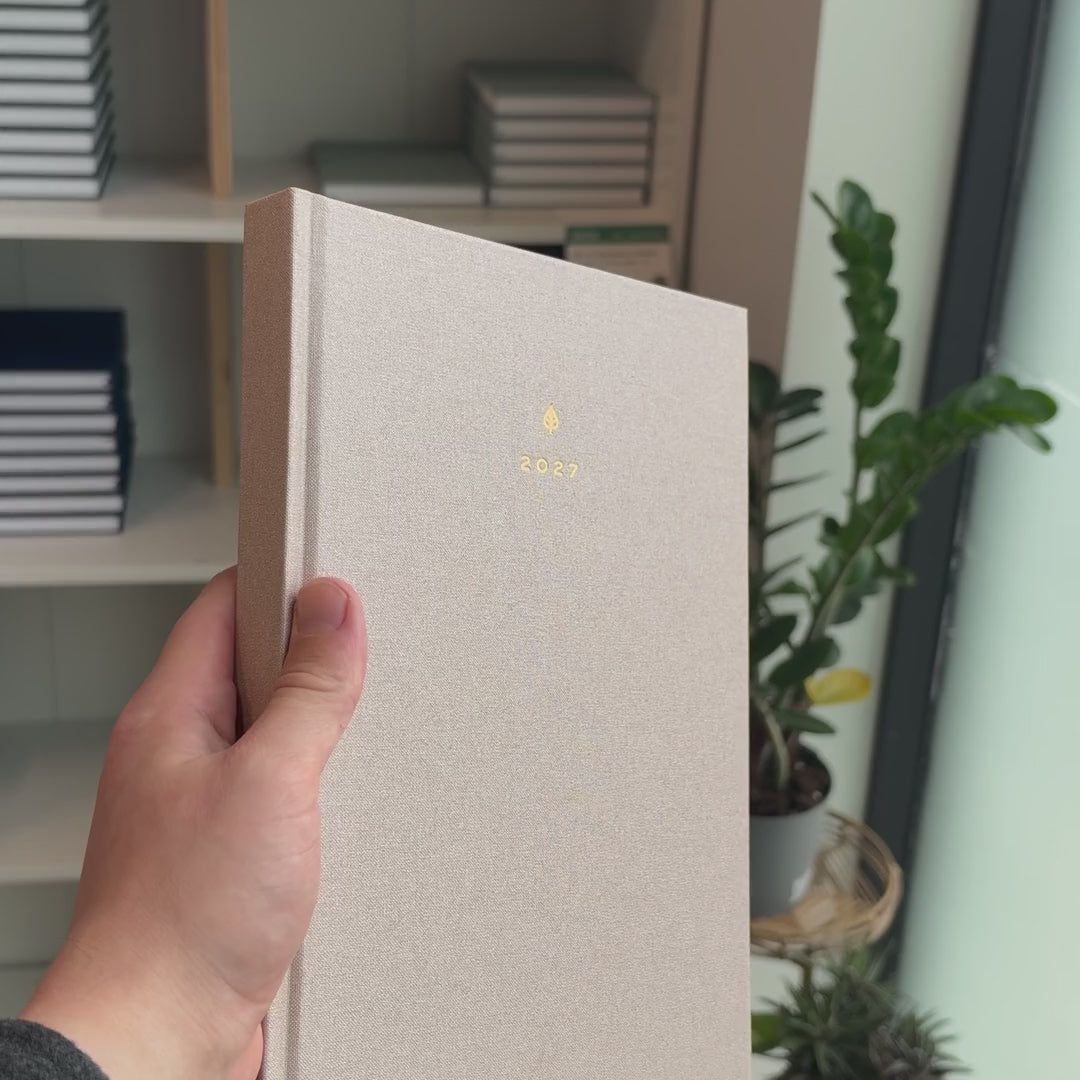 2027 B5 Minimalist Vertical Planner (Hardcover, Heritage 120gsm) in Natural Pearl, held in hand #color_natural pearl
