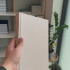 2027 B5 Minimalist Vertical Planner (Hardcover, Heritage 120gsm) in Natural Pearl, held in hand #color_natural pearl