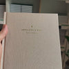 2027 Weekly Planner (Hardcover, Vertical, Heritage 120gsm, A5+) in Natural Pearl, held in hand #color_natural pearl