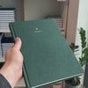 2027 B5 Minimalist Vertical Planner (Hardcover, Heritage 120gsm) in Mystic Forest, held in hand #color_mystic forest