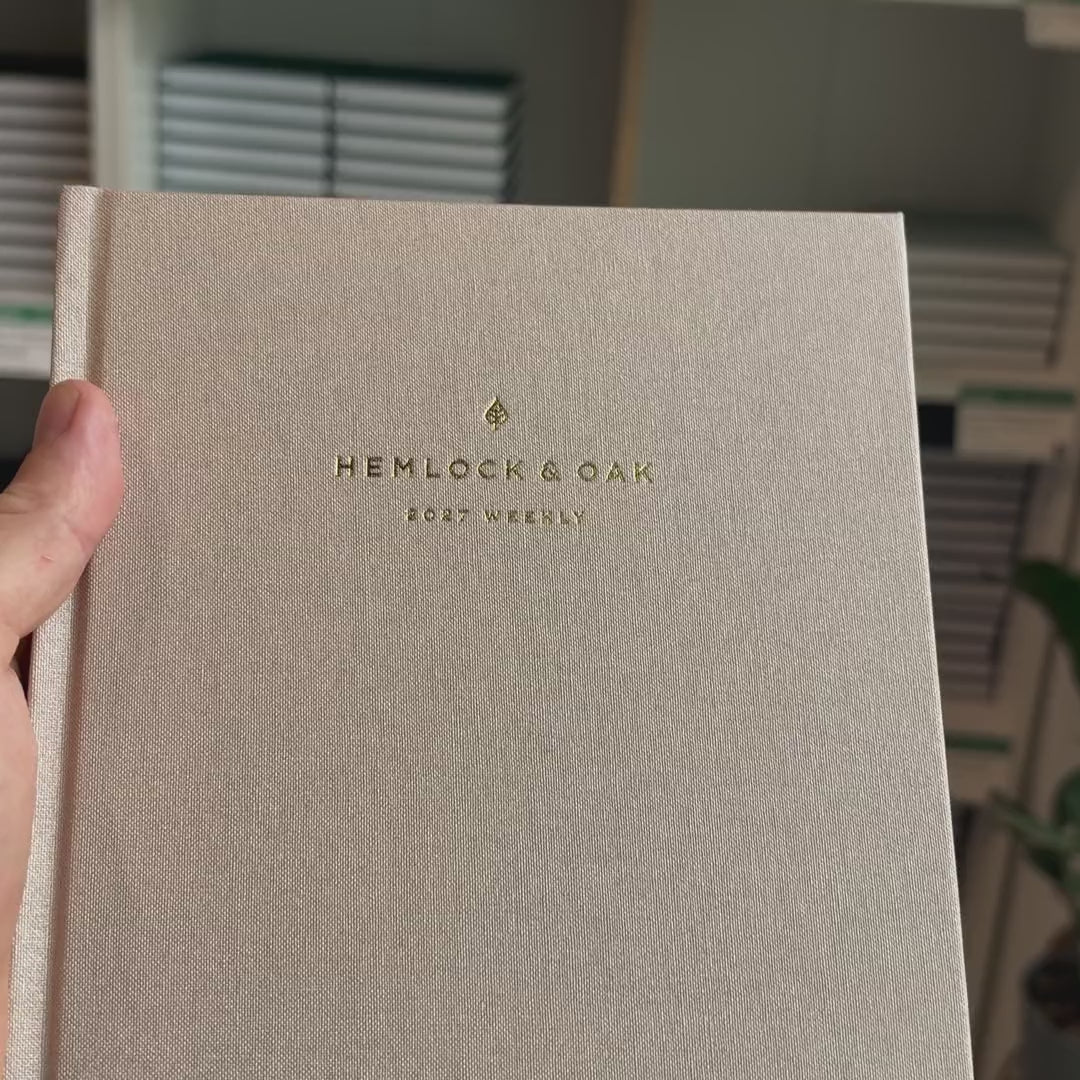 2027 Sunday Start Weekly Planner (Hardcover, Vertical, Heritage 120gsm, A5+) in Natural Pearl, held in hand #color_natural pearl