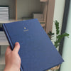 2027 B5 Minimalist Vertical Planner (Hardcover, Heritage 120gsm) in Empress, held in hand #color_empress