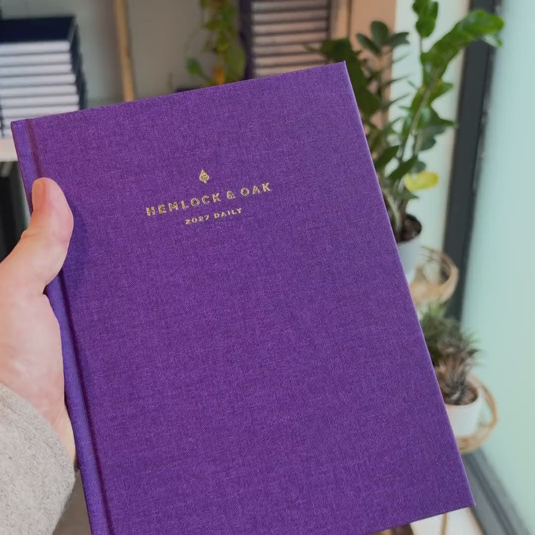 2027 Signature Daily Planner (Hardcover, A5+, Archivist 70gsm) in Aura, held in hand #color_aura