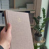 2027 B5 Minimalist Vertical Planner (Hardcover, Heritage 120gsm) in Fawn, held in hand #color_fawn