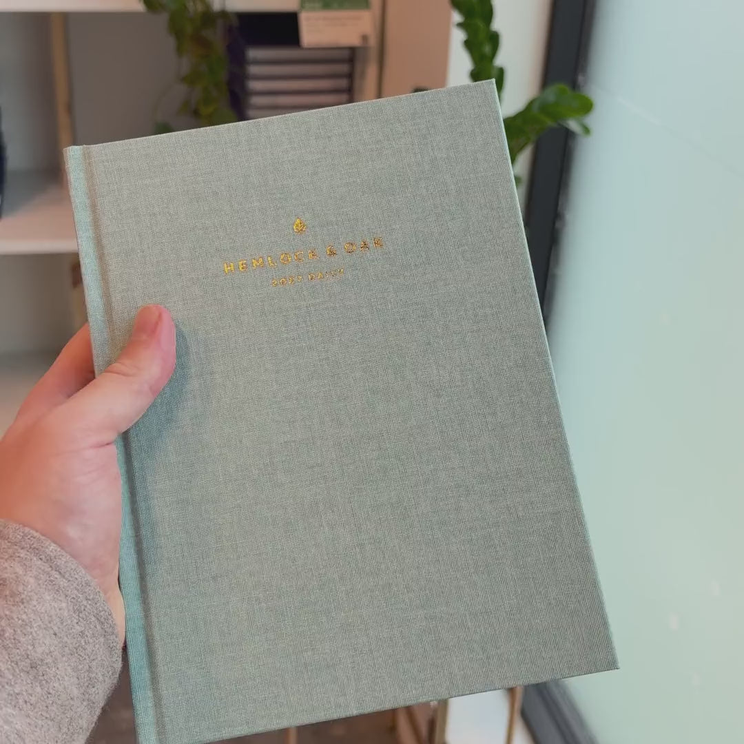 2027 Signature Daily Planner (Hardcover, A5+, Archivist 70gsm) in Moonflower, held in hand #color_moonflower