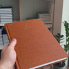 2027 B5 Minimalist Vertical Planner (Hardcover, Heritage 120gsm) in Autumnal, held in hand #color_autumnal