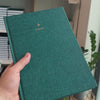 2027 B5 Minimalist Vertical Planner (Hardcover, Heritage 120gsm) in Enchanted Forest, held in hand #color_enchanted forest