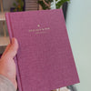 2027 Signature Daily Planner (Hardcover, A5+, Archivist 70gsm) in Wild Rose, held in hand #color_wild rose