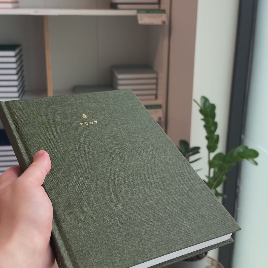 2027 B5 Minimalist Vertical Planner (Hardcover, Heritage 120gsm) in Moss, held in hand #color_moss