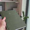 2027 B5 Minimalist Vertical Planner (Hardcover, Heritage 120gsm) in Moss, held in hand #color_moss