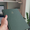 2027 B5 Minimalist Vertical Planner (Hardcover, Heritage 120gsm) in Woodlands, held in hand #color_woodlands