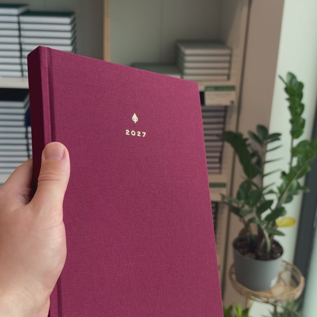 2027 B5 Minimalist Vertical Planner (Hardcover, Heritage 120gsm) in Mulberry, held in hand #color_mulberry