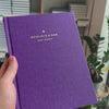 2027 Weekly Planner (Hardcover, Vertical, Heritage 120gsm, A5+) in Aura, held in hand #color_aura