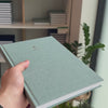 2027 B5 Minimalist Vertical Planner (Hardcover, Heritage 120gsm) in Moonflower, held in hand #color_moonflower
