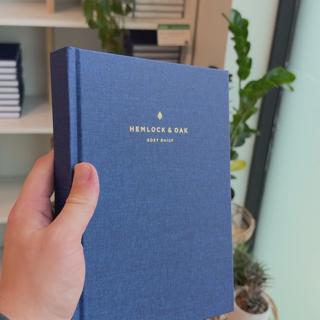 2027 Signature Daily Planner (Hardcover, A5+, Archivist 70gsm) in Empress, held in hand #color_empress