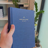 2027 Signature Daily Planner (Hardcover, A5+, Archivist 70gsm) in Empress, held in hand #color_empress