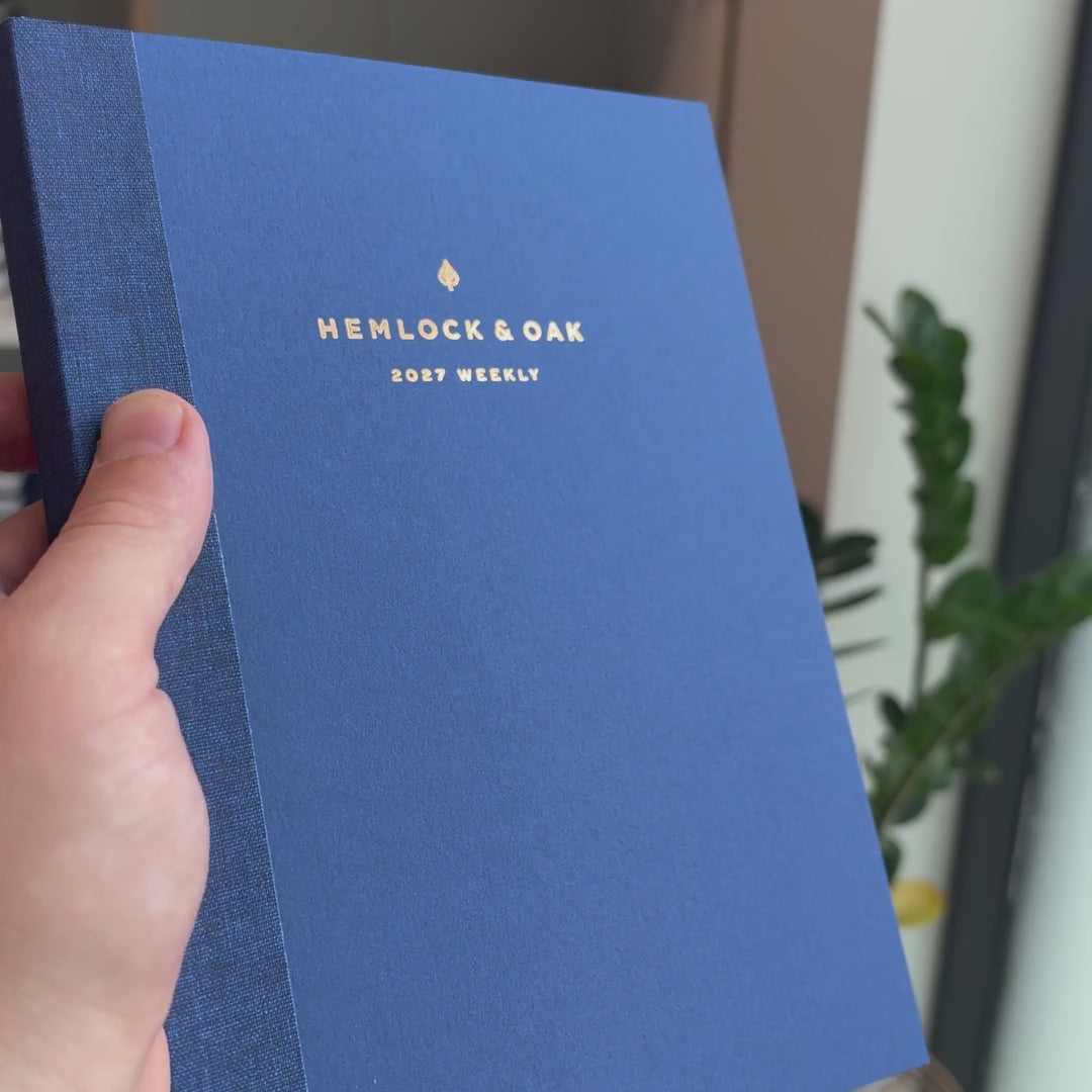 2027 Weekly Planner (Paper Flex, Heritage 120gsm, A5+) in Blueberry, held in hand #color_blueberry