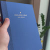 2027 Weekly Planner (Paper Flex, Heritage 120gsm, A5+) in Blueberry, held in hand #color_blueberry