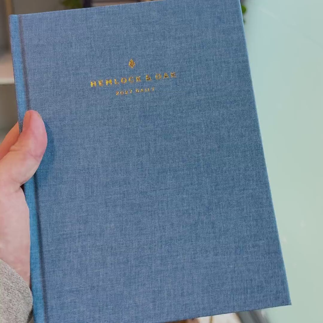 2027 Signature Daily Planner (Hardcover, A5+, Archivist 70gsm) in Spring, held in hand #color_spring