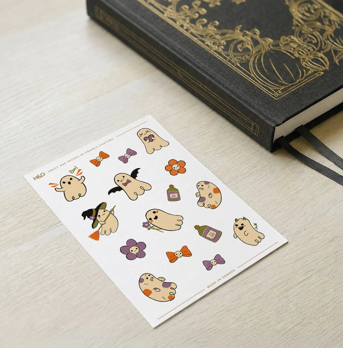 Sweet and Spooky sticker sheet by Frankie Couture shown with a notebook